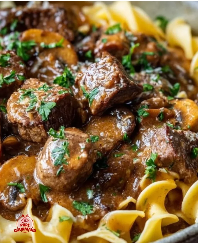 Creamy Beef Stroganoff served with egg noodles and garnished with parsley