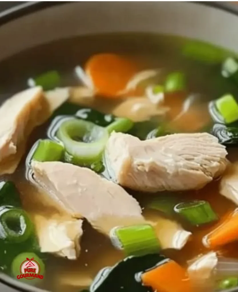 Bowl of cozy chicken miso soup with fresh ingredients and herbs