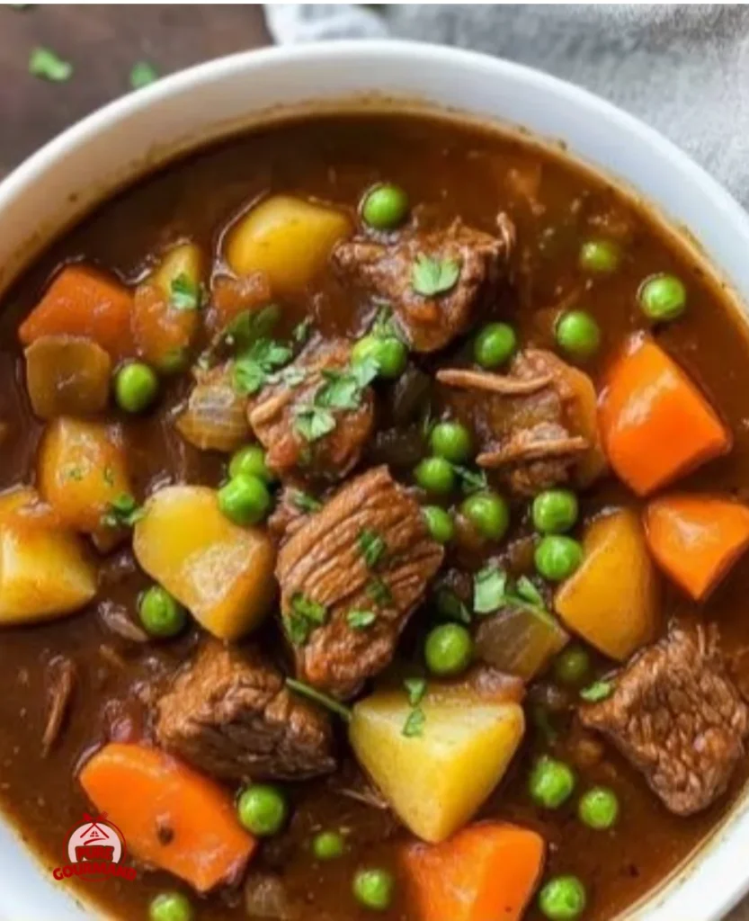 Delicious slow cooker beef stew served in a bowl with vegetables and herbs.