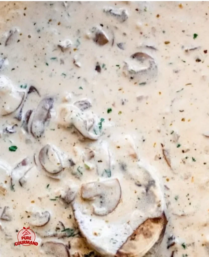 Creamy mushroom pasta sauce served over fettuccine with herbs and cheese.