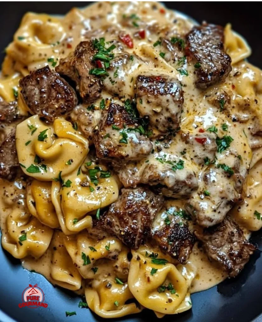 Creamy steak and cheesy tortellini skillet dish served in a pan