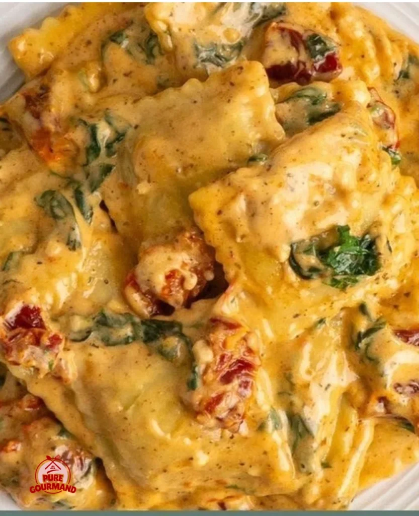 Creamy Tuscan ravioli served with a garnish of herbs on a plate