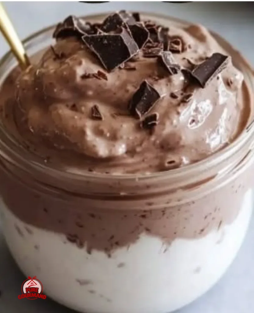 Decadent chocolate Greek yogurt dessert in a bowl garnished with chocolate shavings.