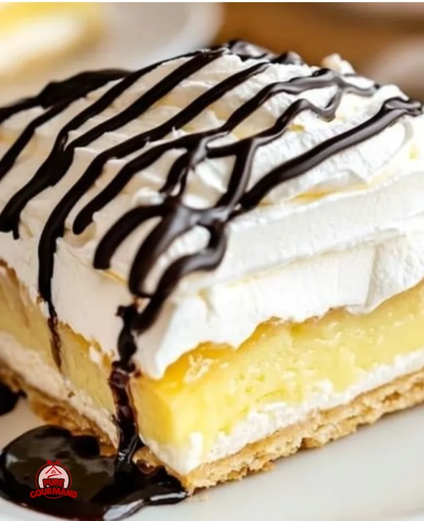 Slice of easy classic cream puff cake topped with whipped cream