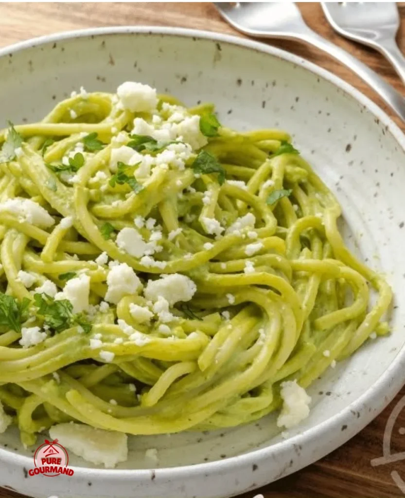 Plate of Espagueti Verde garnished with fresh herbs and vegetables