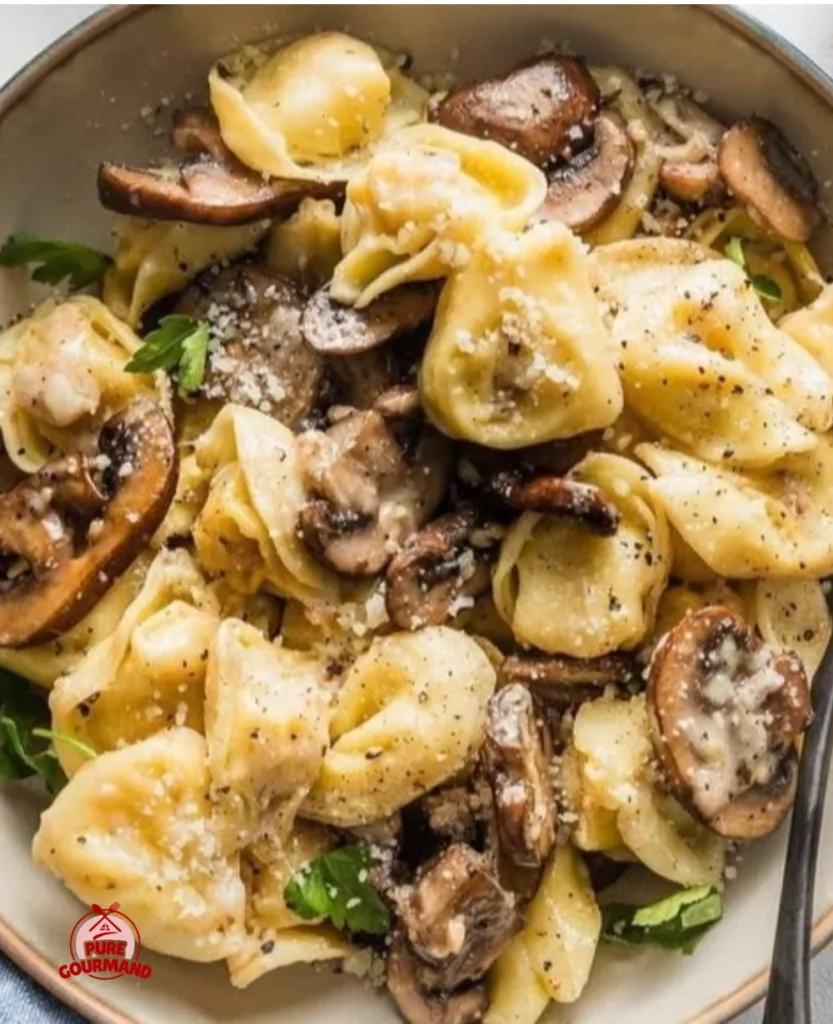 Plate of fresh tortellini with mushrooms, butter, and parmesan cheese
