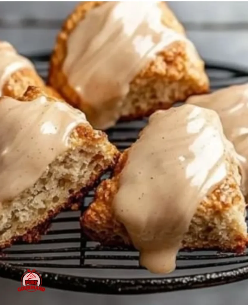 Delicious chai scones drizzled with maple chai glaze on a rustic table.