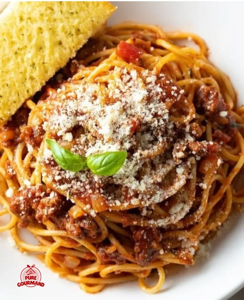 A bowl of Nana's Finest Meat Sauce served over spaghetti, showcasing a family classic dish.