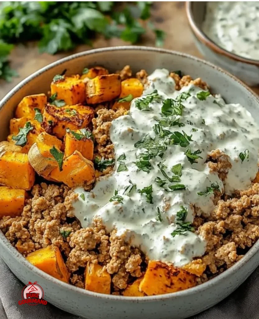 Nutritious ground turkey and sweet potato bowls garnished with fresh herbs.