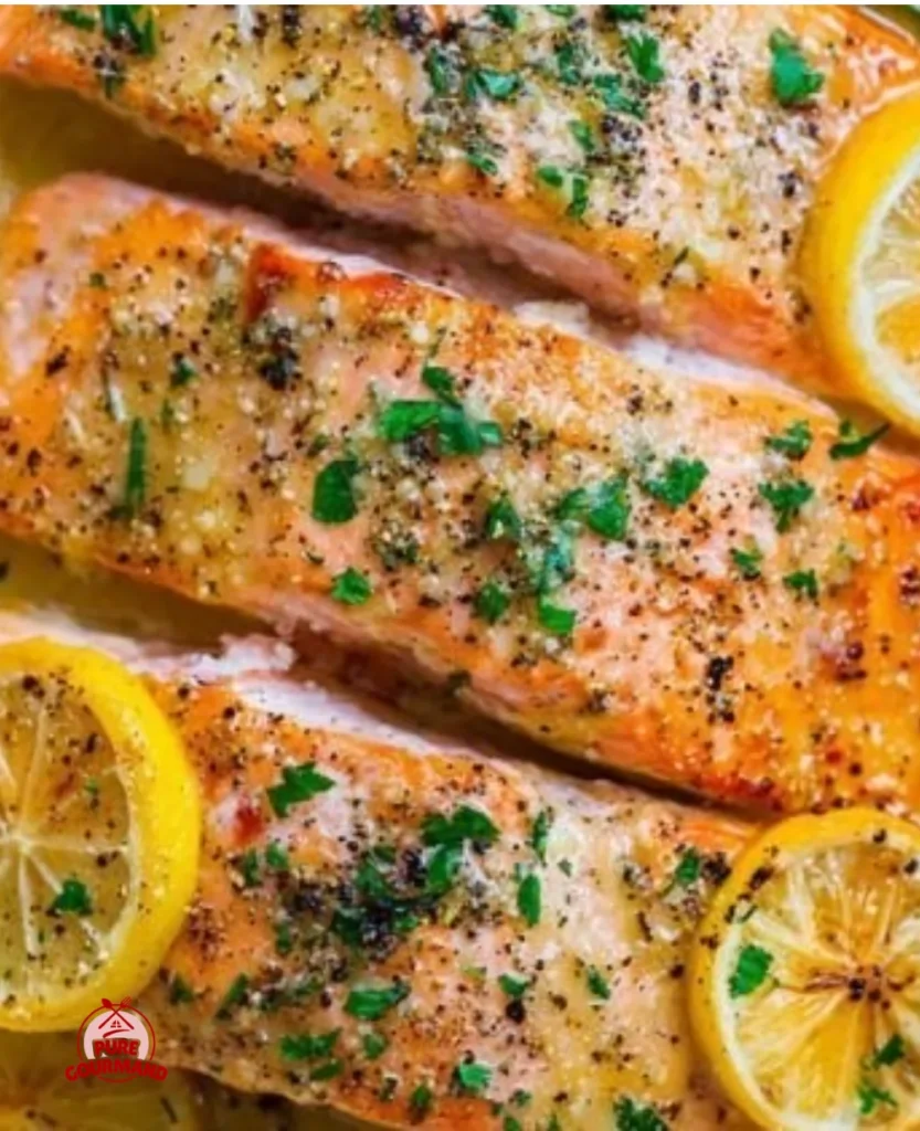 Sheet Pan Lemon Garlic Butter Salmon garnished with fresh herbs on a plate