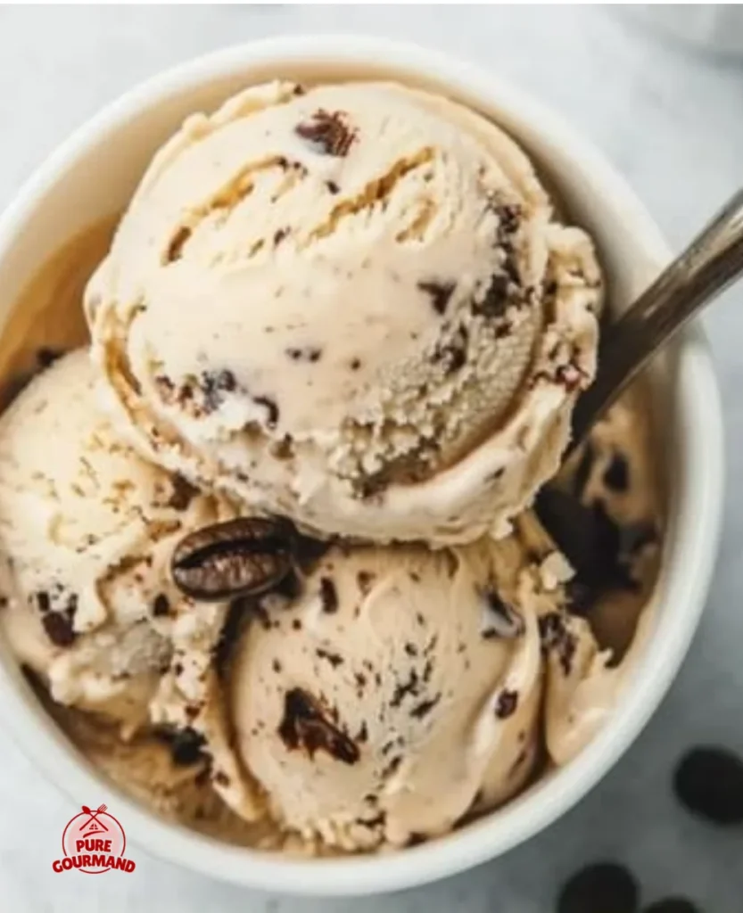 Silky Coffee Clouds no-churn ice cream in a bowl with coffee beans