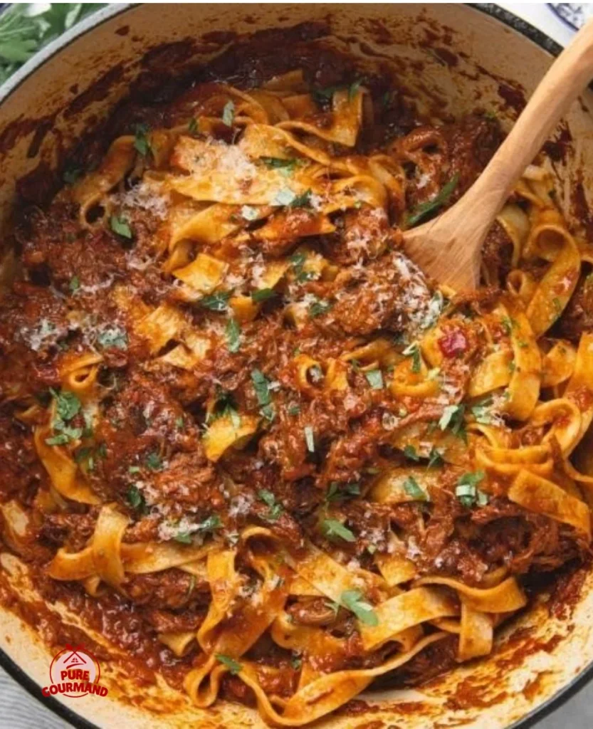 Delicious bowl of slow-simmered short rib ragu with herbs and pasta