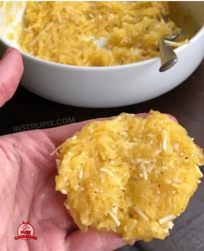 A bowl of spaghetti squash topped with flavorful sauce and herbs, ready for a cozy dinner.