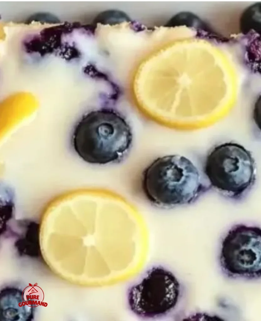 Delicious sun-kissed lemon blueberry sheet cake topped with fresh berries