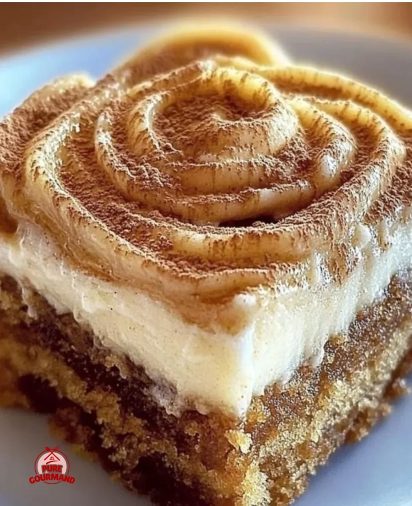 Delicious pumpkin spice gooey cake topped with spices and frosting