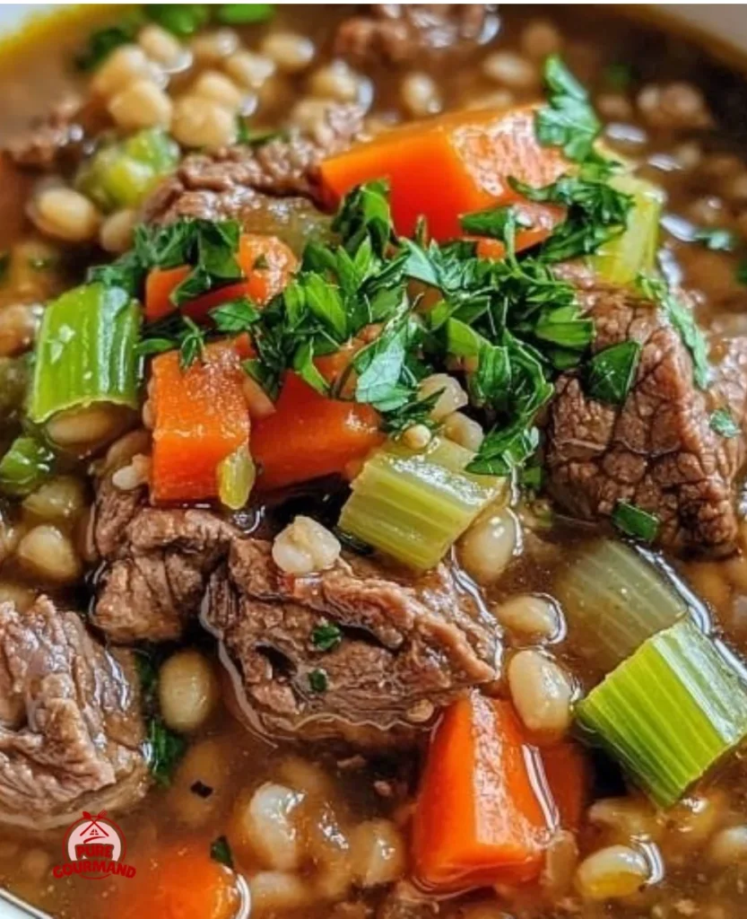 A bowl of Pioneer Woman beef barley soup, steaming and hearty, perfect for comfort food.