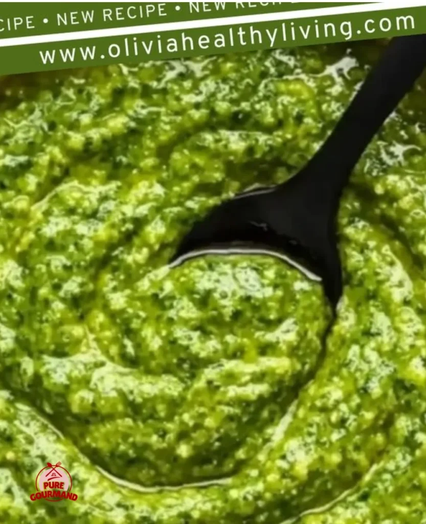 A vibrant bowl of homemade garlic scape pesto with fresh ingredients.