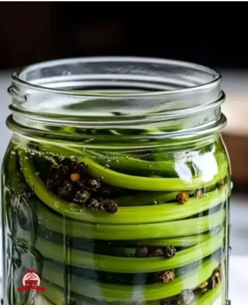 Jar of easy pickled garlic scapes on a kitchen counter