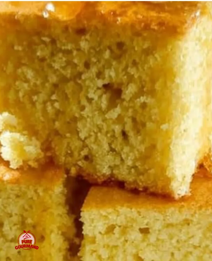 Freshly baked buttermilk cornbread golden and fluffy on a wooden table.