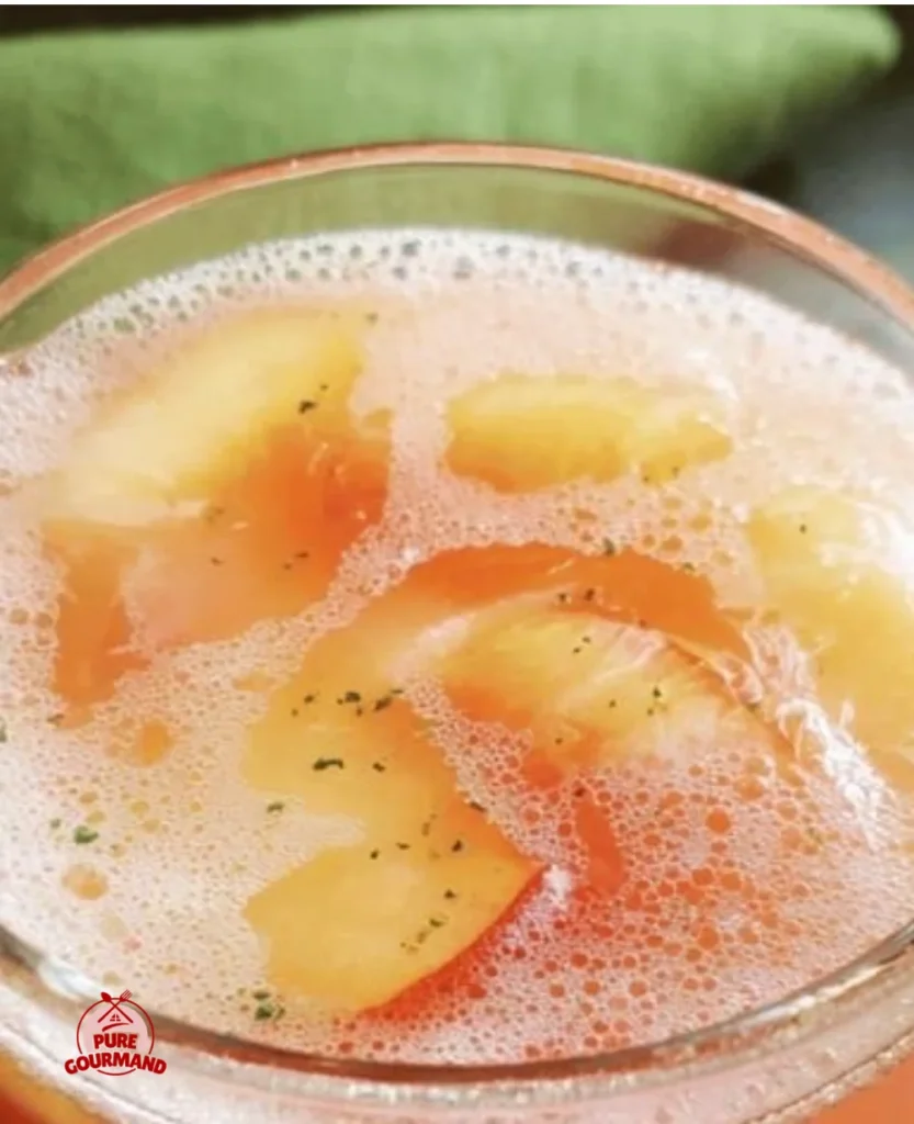 A glass of Grandma's Peach Punch, a nostalgic summer beverage.