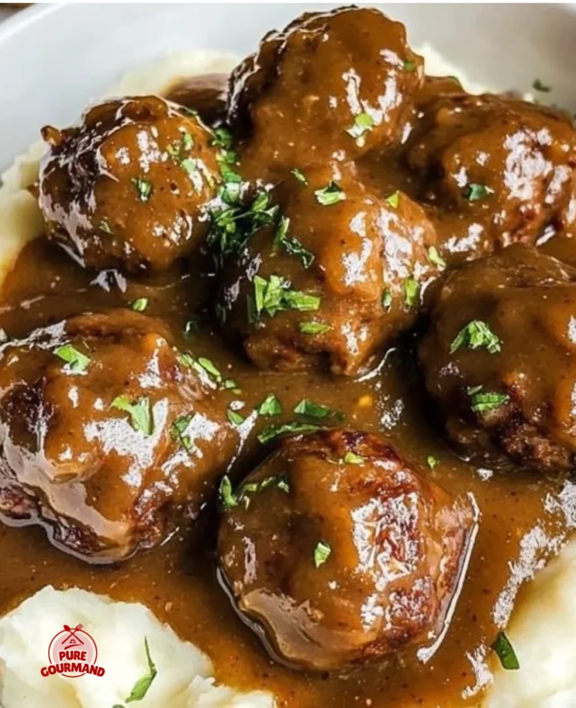 Juicy meatballs in a savory gravy served on a plate