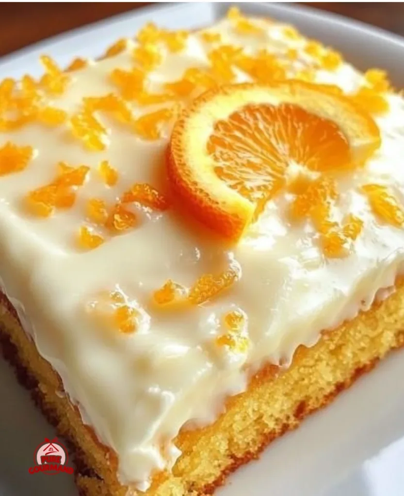 Moist orange sheet cake with citrus frosting topped with orange slices.