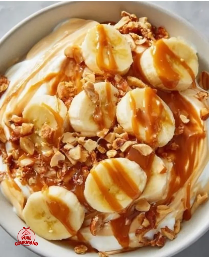 Salted Caramel Banana Yogurt Bowl topped with fresh banana slices and drizzled caramel.
