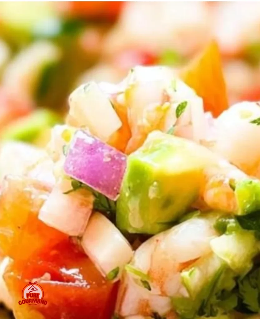 A bowl of fresh shrimp ceviche garnished with lime and cilantro.