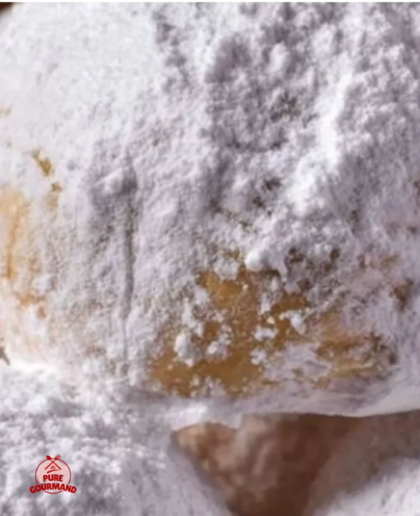 Plate of snowball cookies dusted with powdered sugar, a holiday treat
