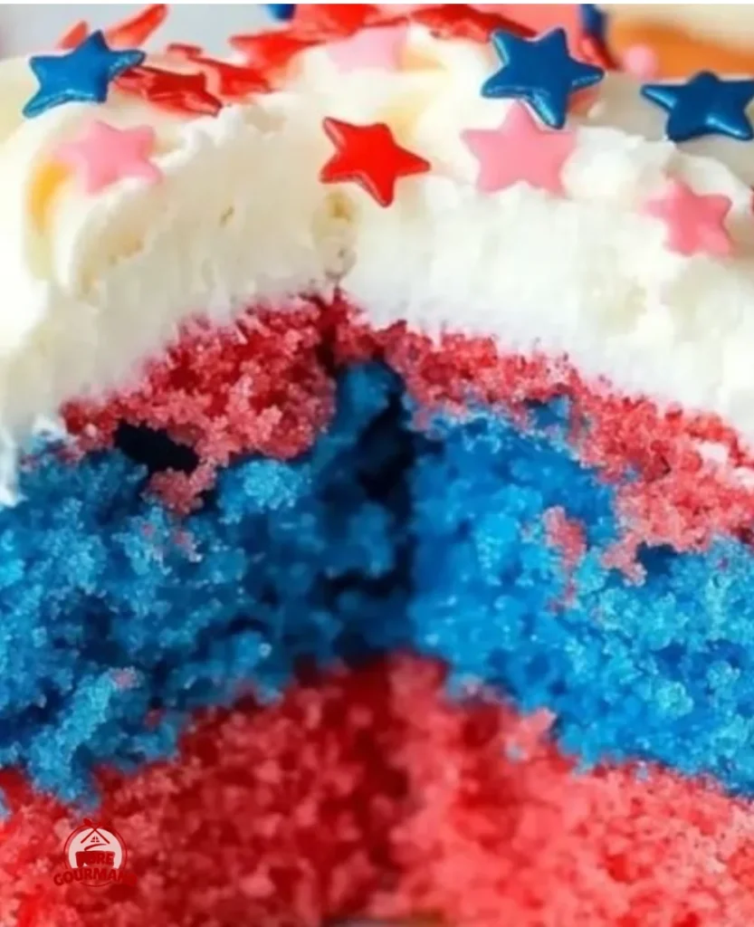Swirled red, white & blue cupcakes topped with festive decorations for celebrations