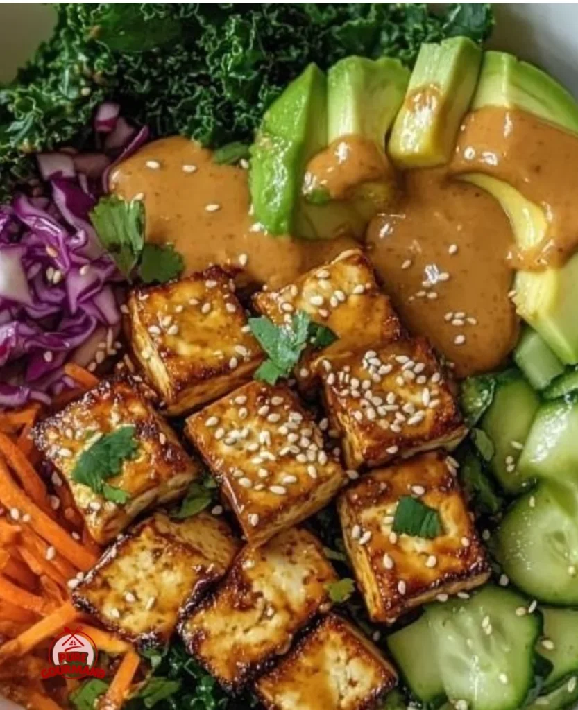 Tofu Buddha Bowl topped with vibrant veggies and drizzled with peanut sauce.