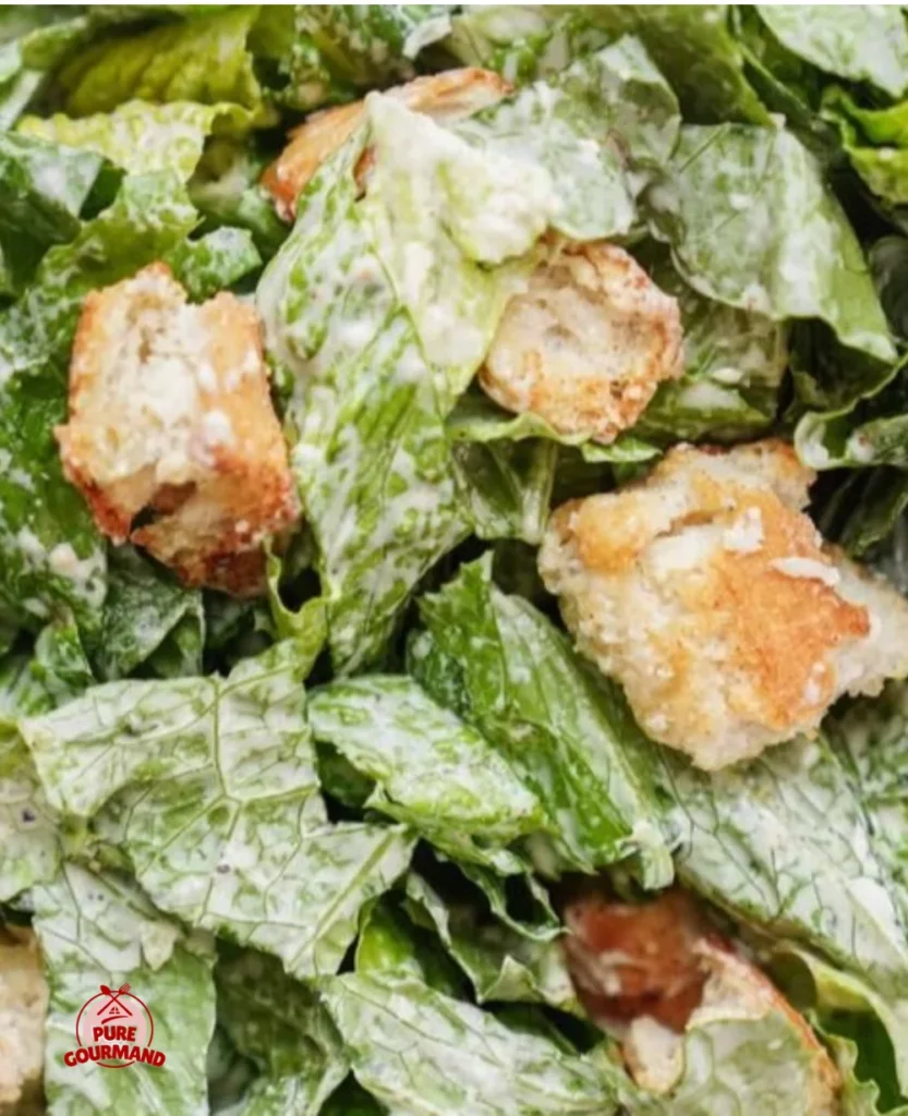 Bowl of Classic Caesar Dressing with ingredients for a creamy, zesty salad emulsion.