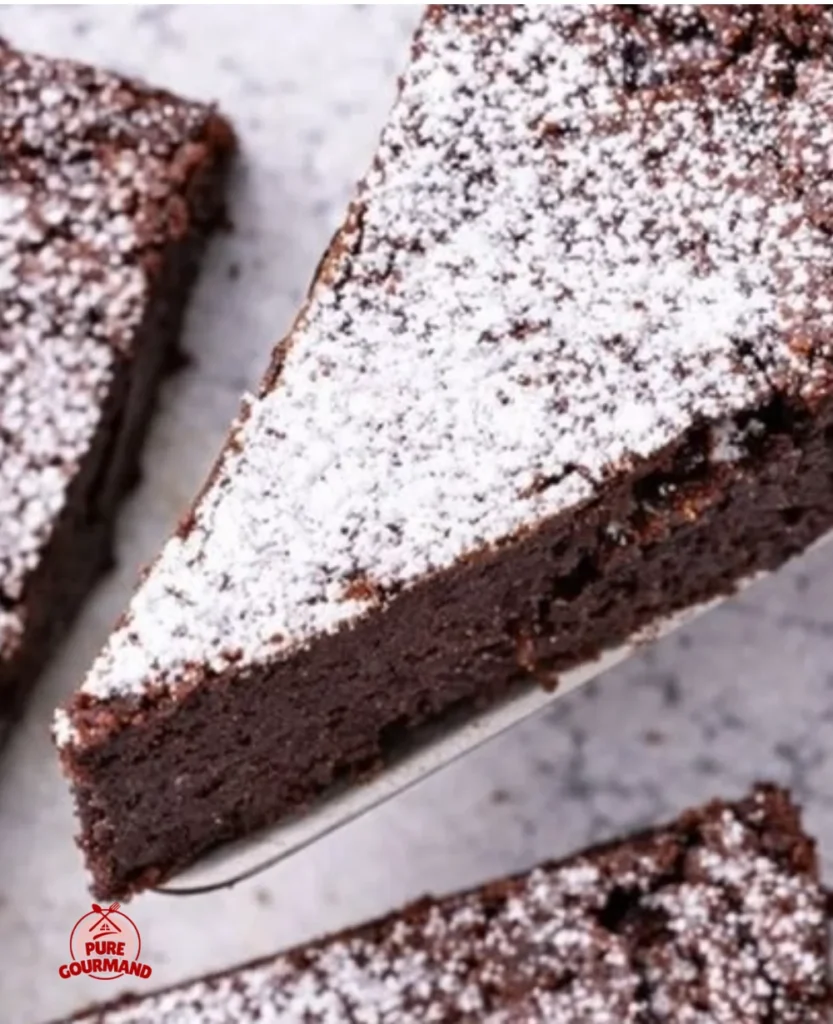 Decadent Flourless Chocolate Cake served on a plate with a garnish