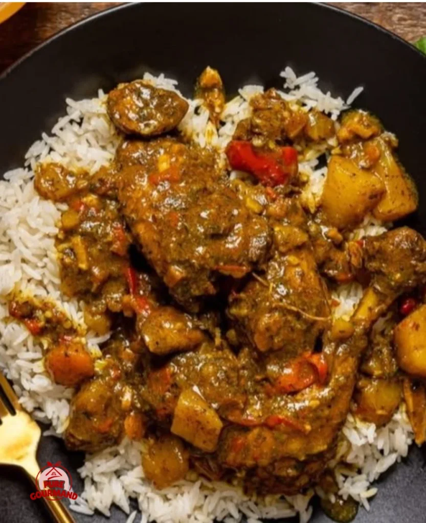 Jamaican curry chicken served with rice and colorful vegetables