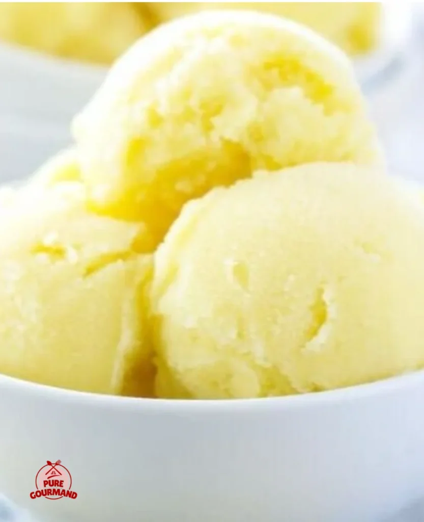 Bowl of pineapple coconut sorbet topped with fresh fruit