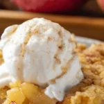 3-Ingredient Apple Dump Cake served in a dish with apples and cake topping