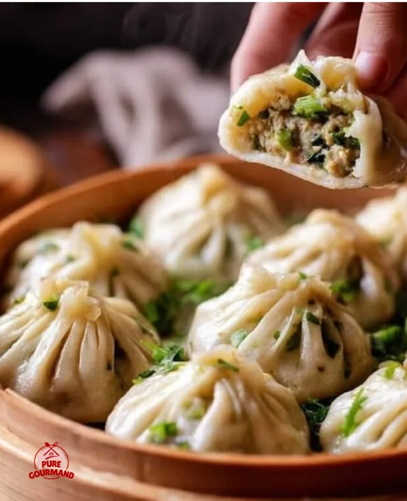 Plate of authentic Chicken Momos served with chili dipping sauce