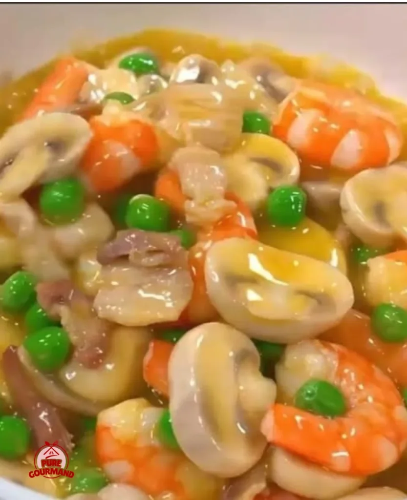 Braised shrimp with button mushrooms served in a savory sauce.
