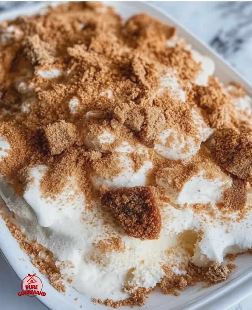 A light and crunchy Butterfinger Angel Food Cake dessert topped with candy pieces.