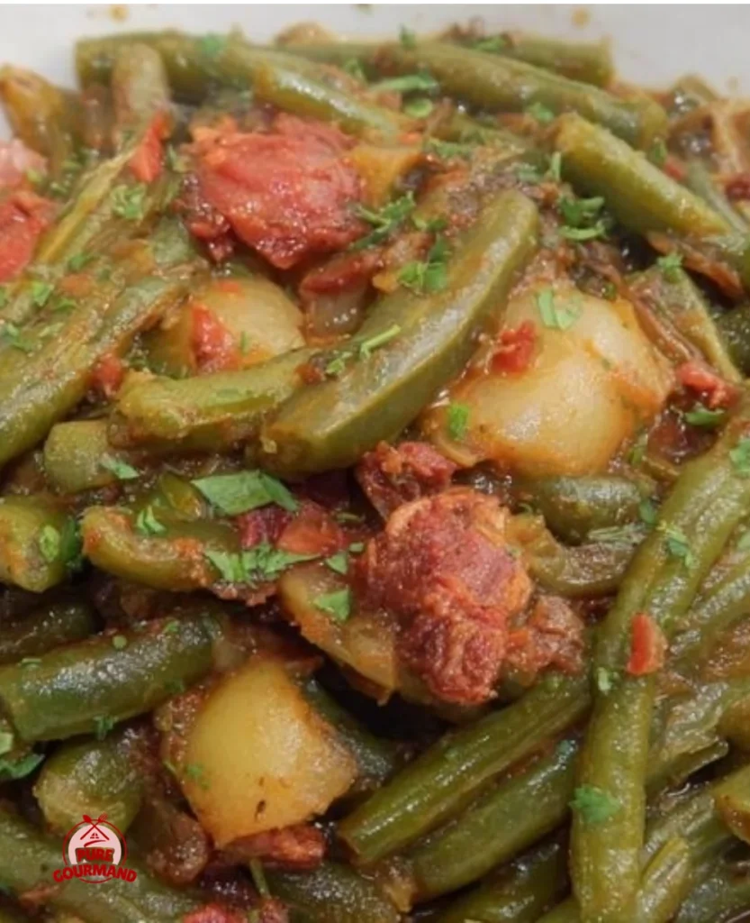 Cajun-Style smothered green beans served in a bowl with seasoning and spices