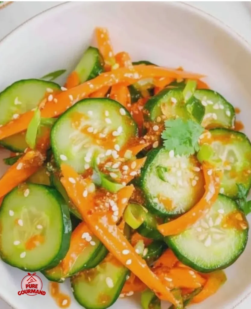 Crisp carrot cucumber salad topped with a spicy dressing