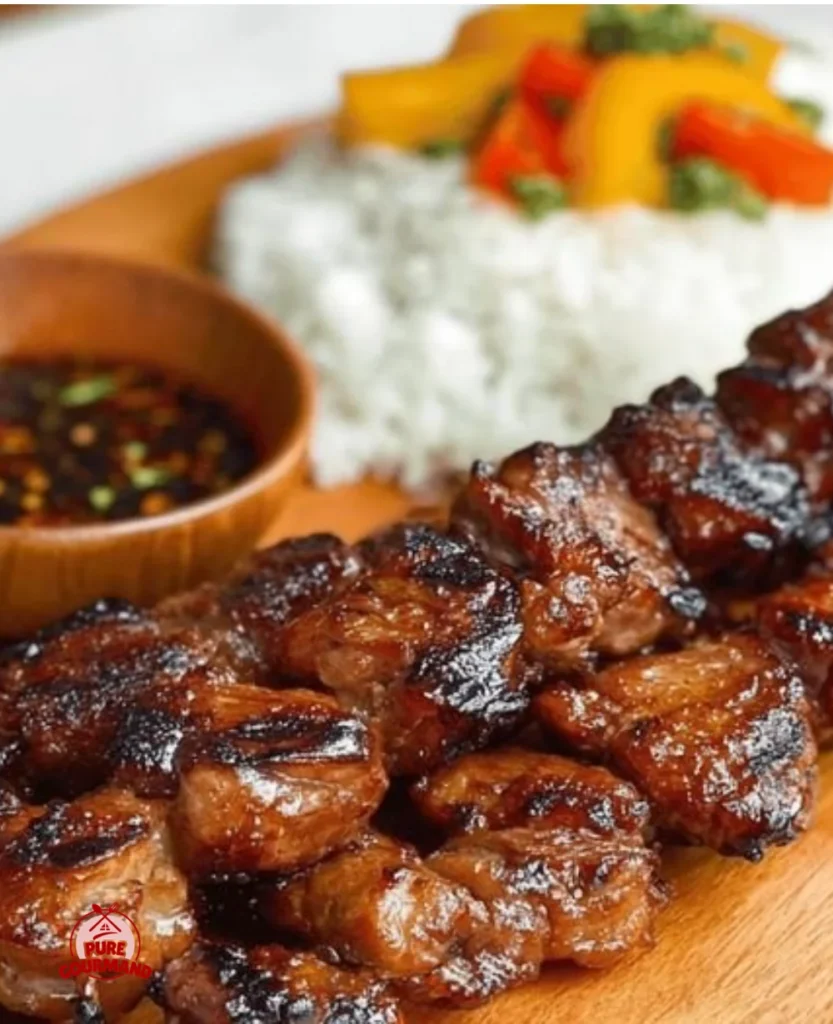 Delicious Filipino Pork BBQ skewers on the grill, showcasing marinated meat.
