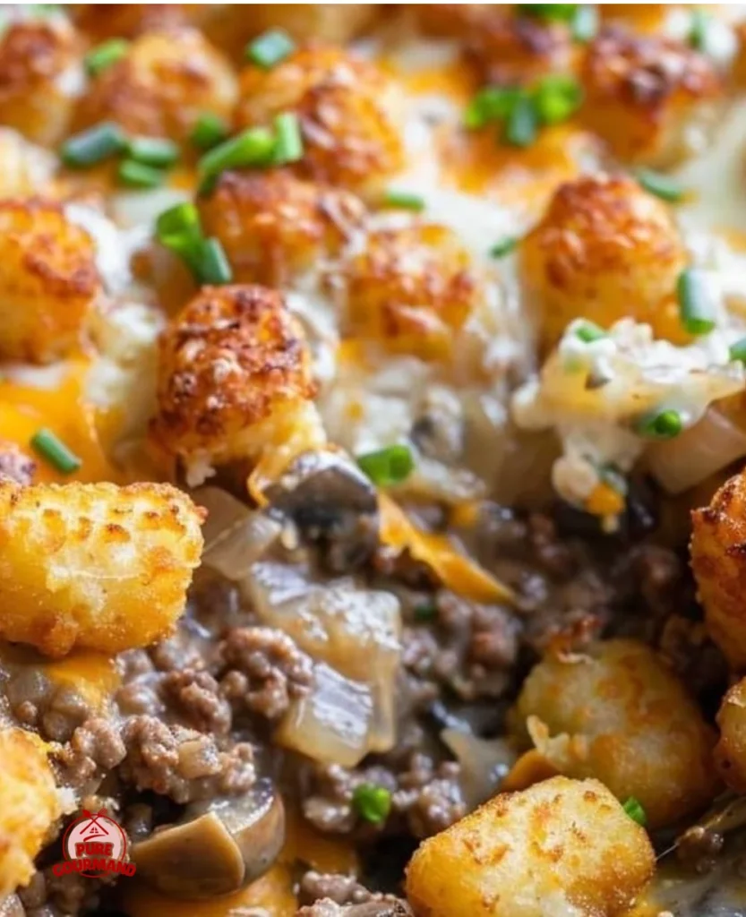 Cheesy Tater Tot Casserole with crispy edges in a skillet.