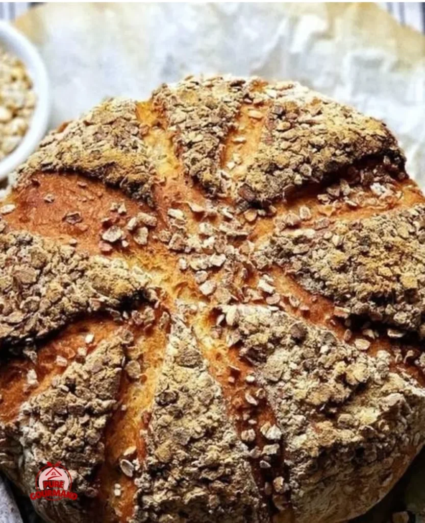 Freshly baked no-knead oat bread with a golden crust and soft interior