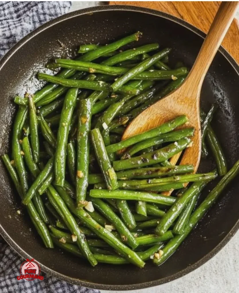 Plate of perfectly sautéed green beans with garlic