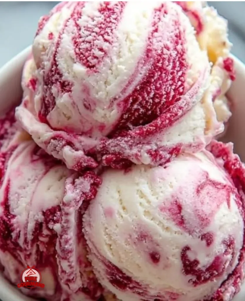Delicious bowl of Raspberry Swirl Ice Cream with fresh raspberries on top