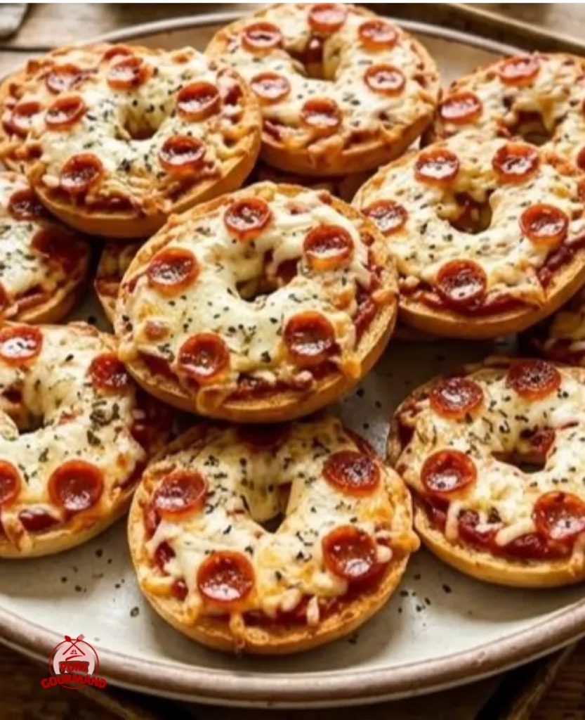 Tiny bagel pizzas topped with cheese and pepperoni on a cozy table