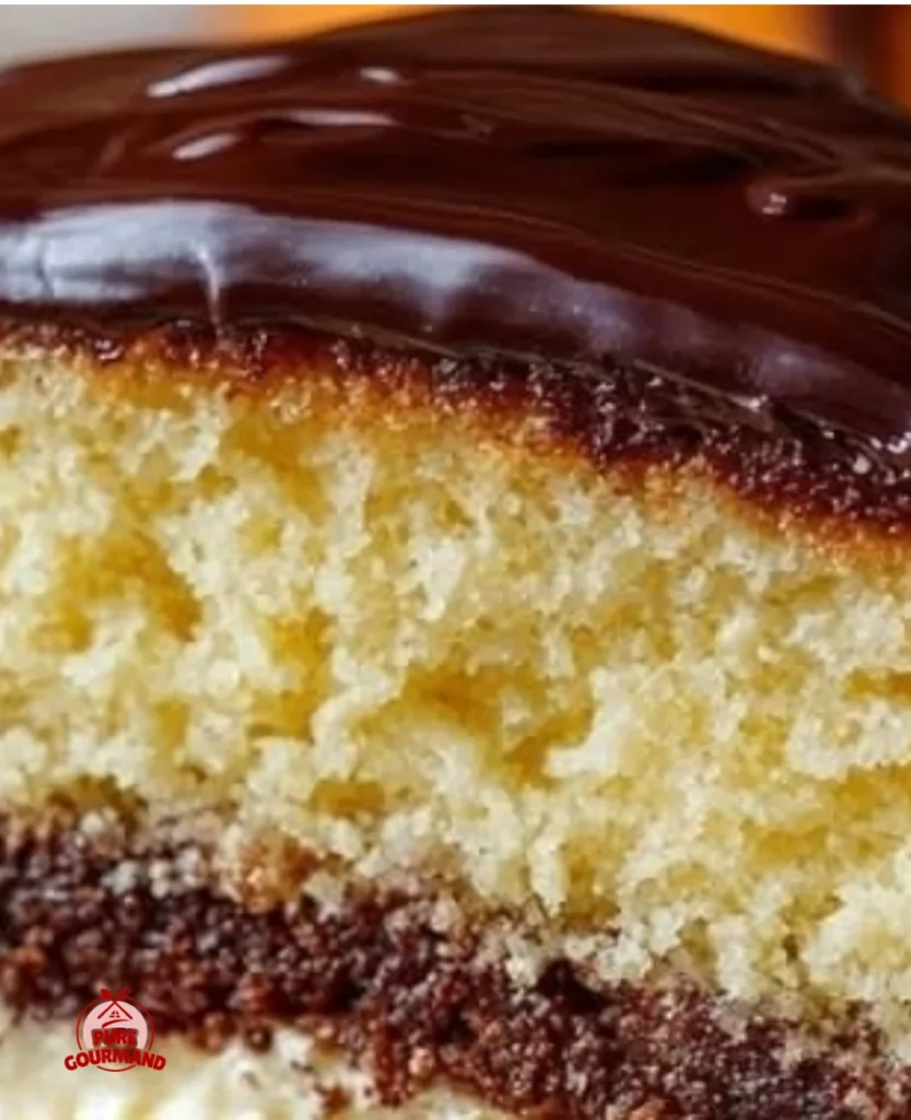 Boston Cream Pie Cake with layers of cream and chocolate glaze.