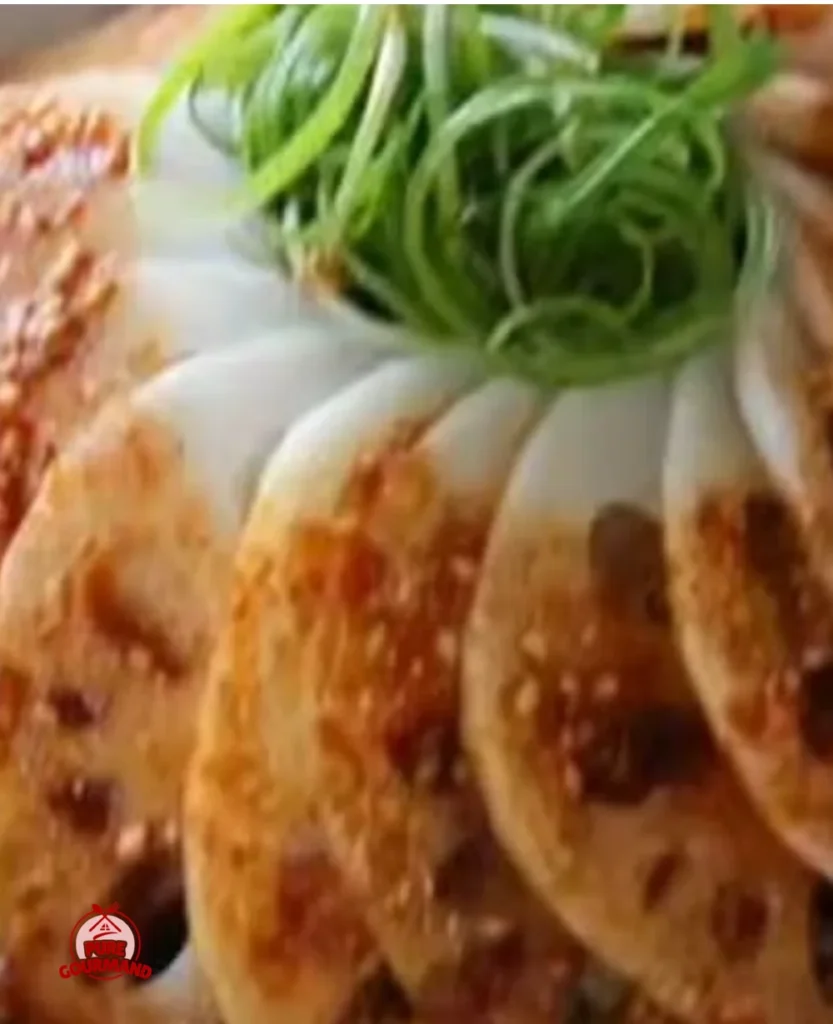 Chilled Crispy Lotus Root Salad garnished with fresh herbs and sesame seeds