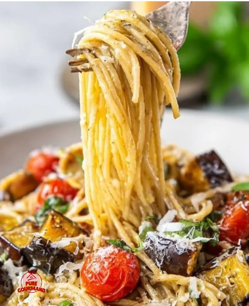 Plate of easy aubergine pasta with fresh tomatoes and garlic